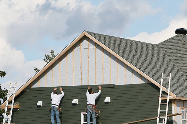 Professional Storm Damage Siding Repair technician working in Bedford, MA